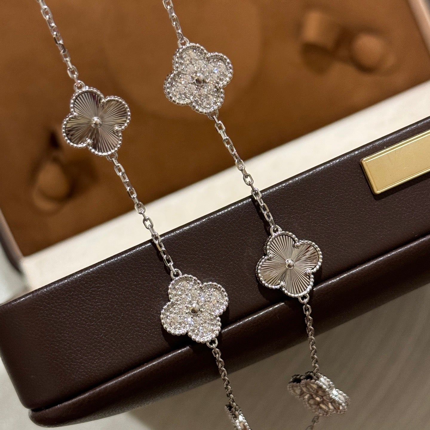 Laser-cut four-leaf clover necklace with interspersed diamonds and ten flowers