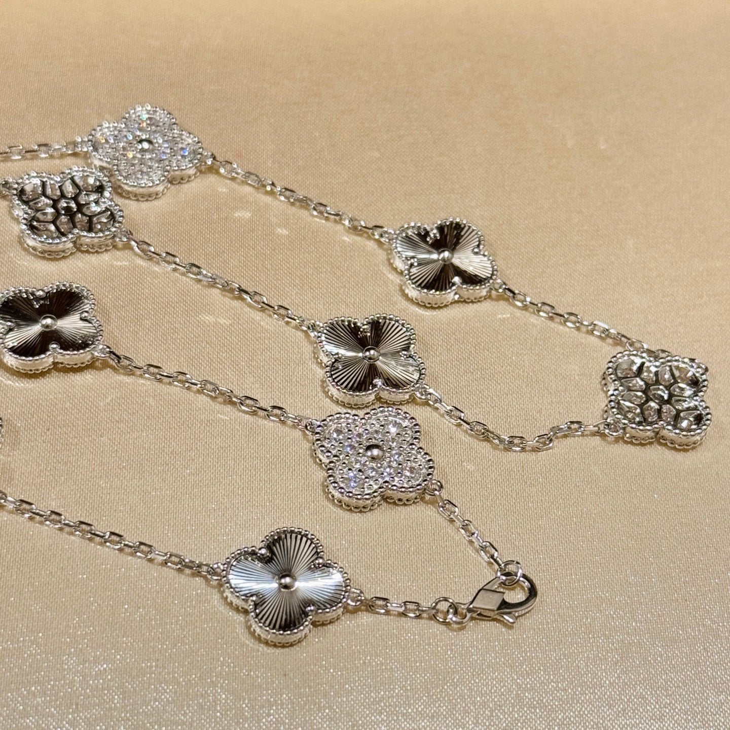 Laser-cut four-leaf clover necklace with interspersed diamonds and ten flowers