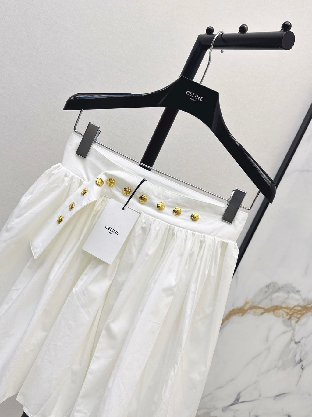 26SS — New skirt with gold buckle design