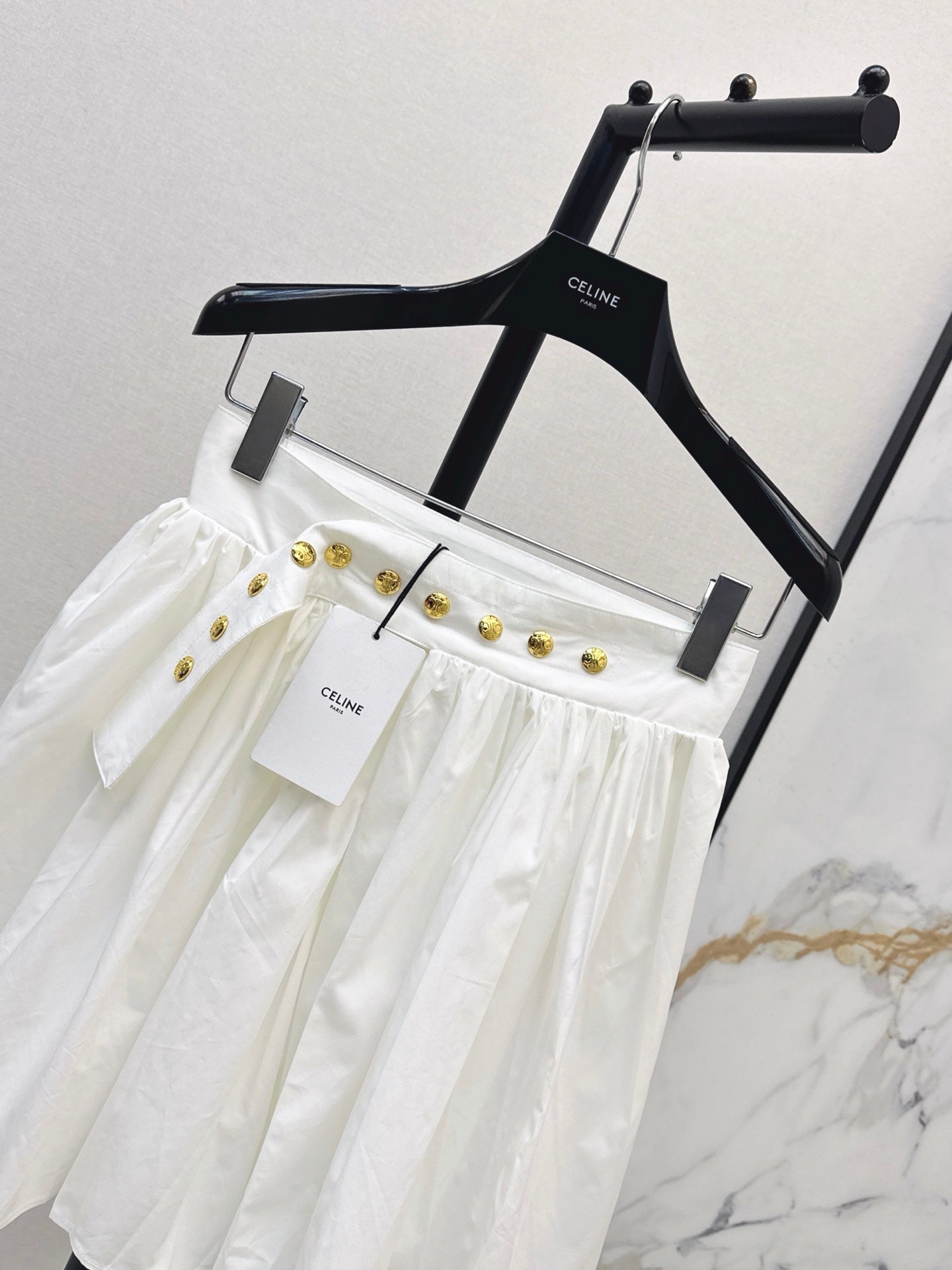 26SS — New skirt with gold buckle design