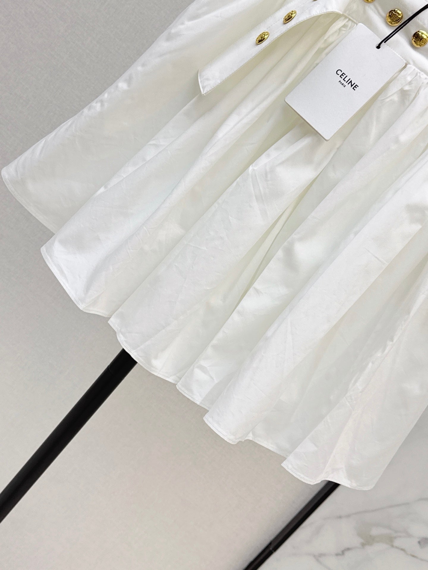 26SS — New skirt with gold buckle design